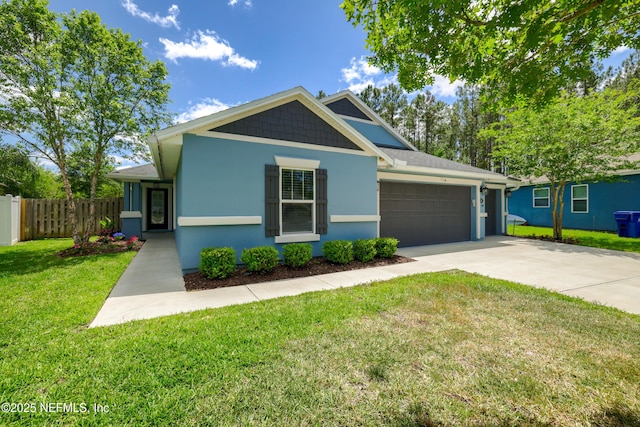 view of front of property with driveway, a garage, fence, a front lawn, and stucco siding