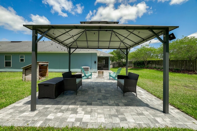 view of patio featuring a gazebo, fence, and an outdoor fire pit