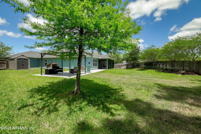 view of yard with a fenced backyard, a storage unit, and a sunroom