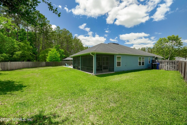 back of property featuring a sunroom, a fenced backyard, and a lawn