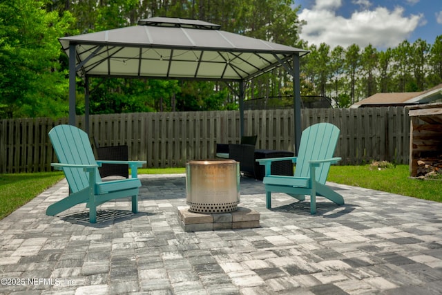 view of patio / terrace featuring a gazebo, fence, and a fire pit