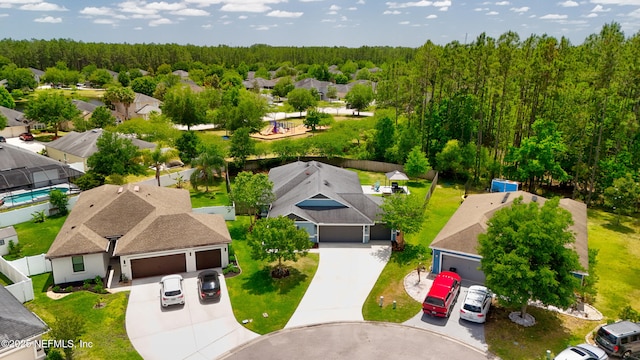 birds eye view of property featuring a residential view and a wooded view
