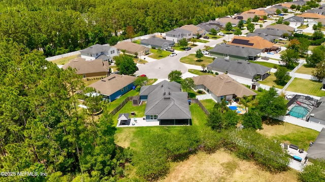 bird's eye view with a residential view and a wooded view