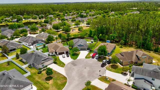 aerial view featuring a residential view, a view of trees, and a water view