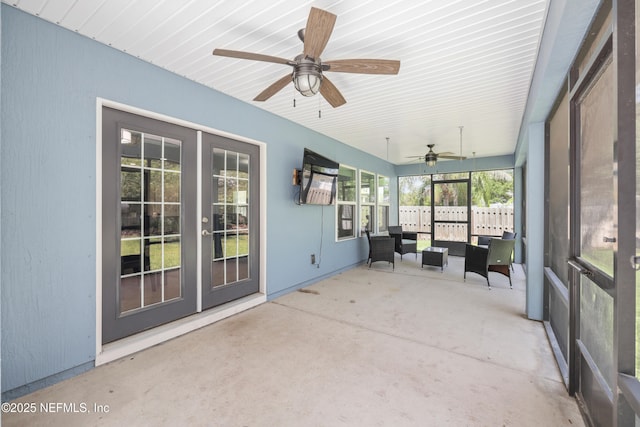 sunroom with ceiling fan and french doors