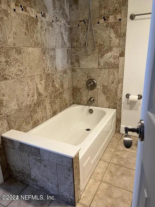 bathroom featuring tub / shower combination and tile patterned floors