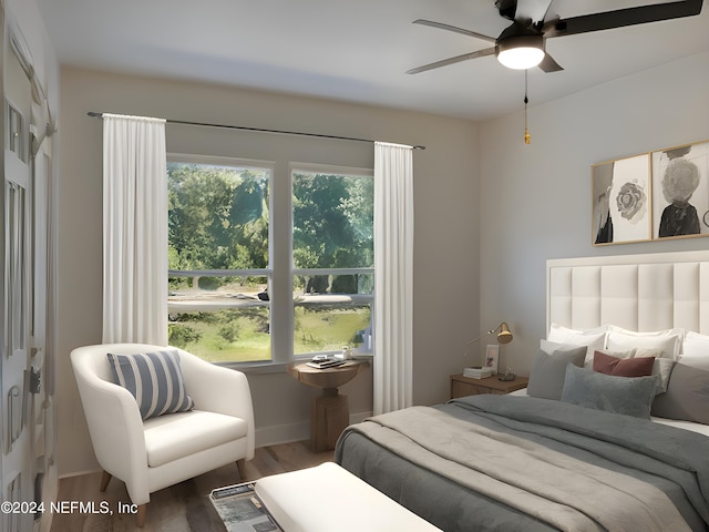 bedroom with baseboards and wood finished floors