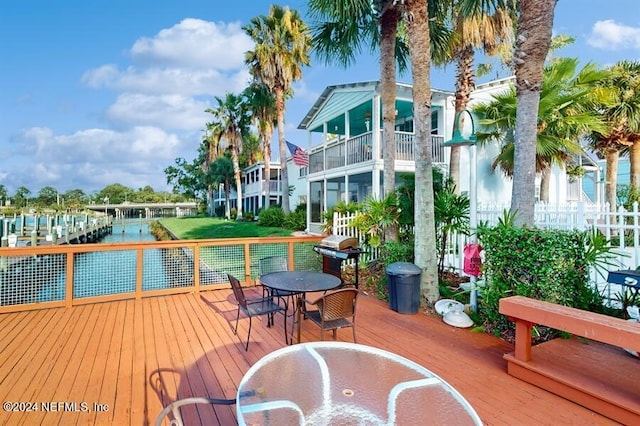 deck with outdoor dining space and a grill