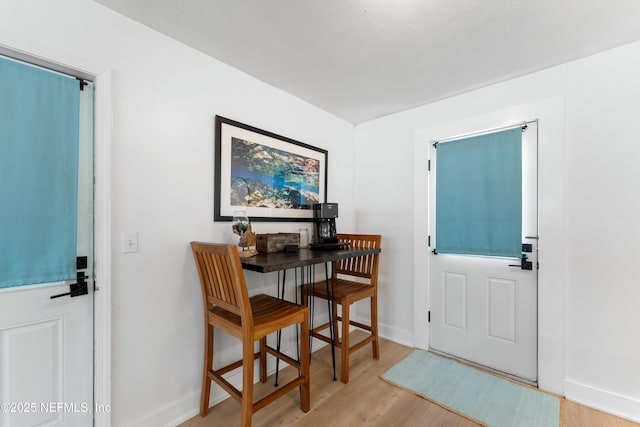 foyer entrance with light wood finished floors and baseboards