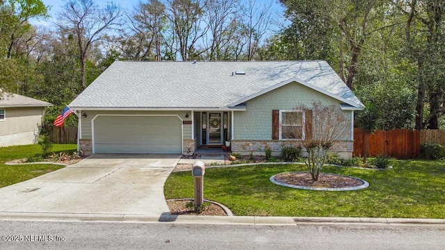 single story home featuring a front yard, concrete driveway, an attached garage, and fence