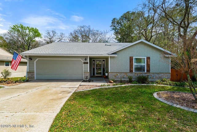 single story home featuring a shingled roof, a front yard, a garage, stone siding, and driveway