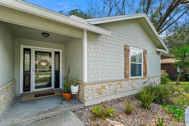 entrance to property featuring stone siding