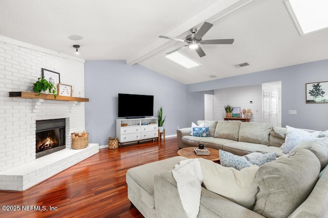 living room with a fireplace, lofted ceiling with beams, baseboards, and wood finished floors