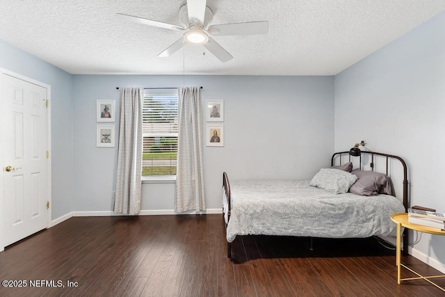 bedroom featuring ceiling fan, baseboards, a textured ceiling, and dark wood finished floors