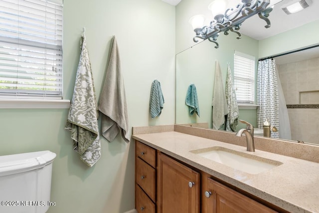 bathroom with a shower with shower curtain, visible vents, toilet, and vanity