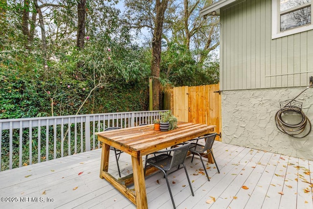 deck featuring outdoor dining space and fence