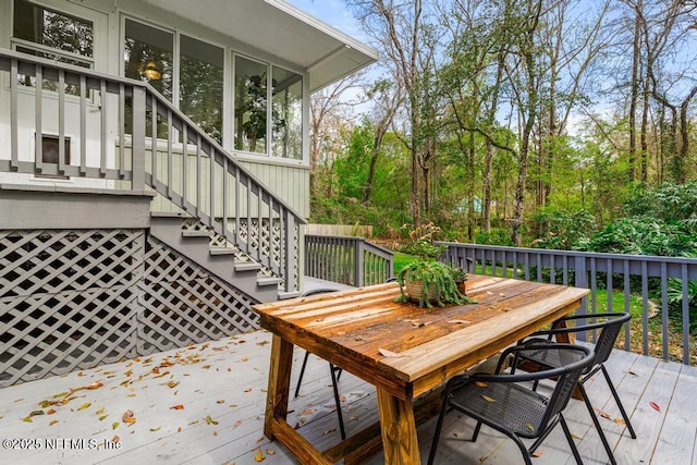 deck featuring stairway and outdoor dining area