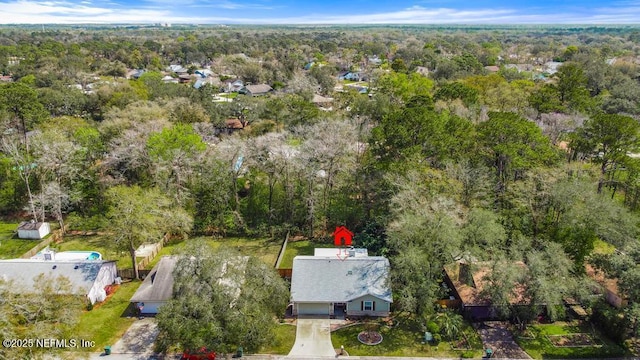 drone / aerial view featuring a forest view