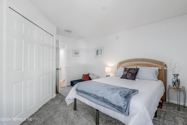 bedroom with carpet floors, a closet, visible vents, and baseboards