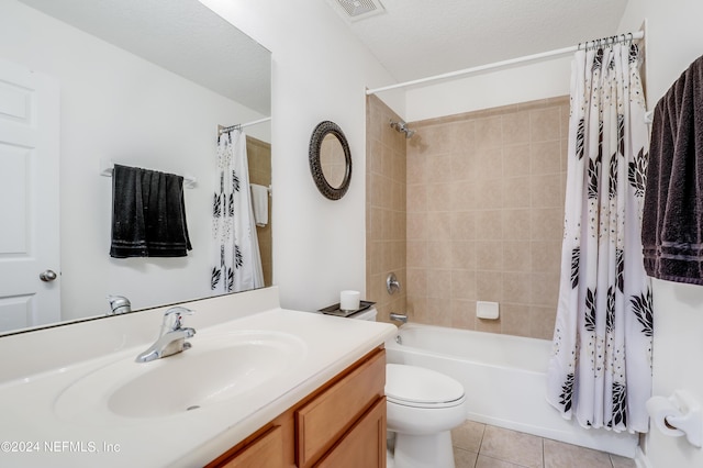 full bathroom with visible vents, toilet, tile patterned flooring, shower / bath combo with shower curtain, and vanity