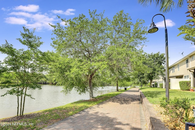 view of community featuring a water view and a lawn