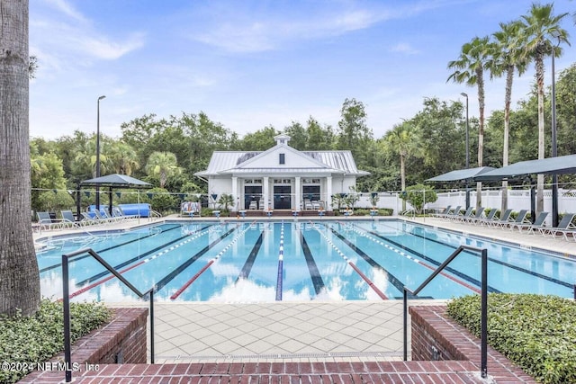 pool featuring a patio area and fence