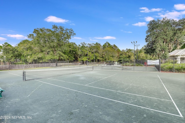 view of sport court featuring fence