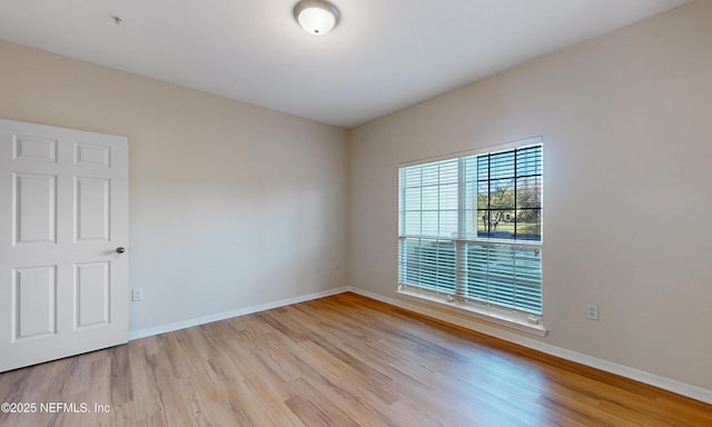 unfurnished room featuring light wood-type flooring and baseboards