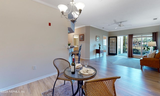 interior space featuring light wood finished floors, baseboards, visible vents, and crown molding