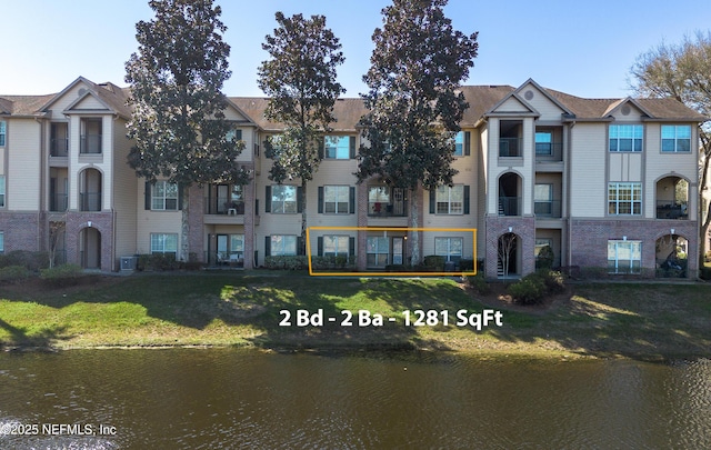 view of property featuring a water view and central air condition unit