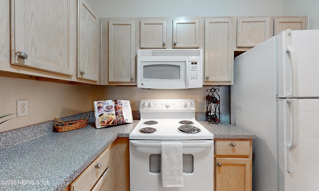 kitchen featuring white appliances, light countertops, and light brown cabinetry