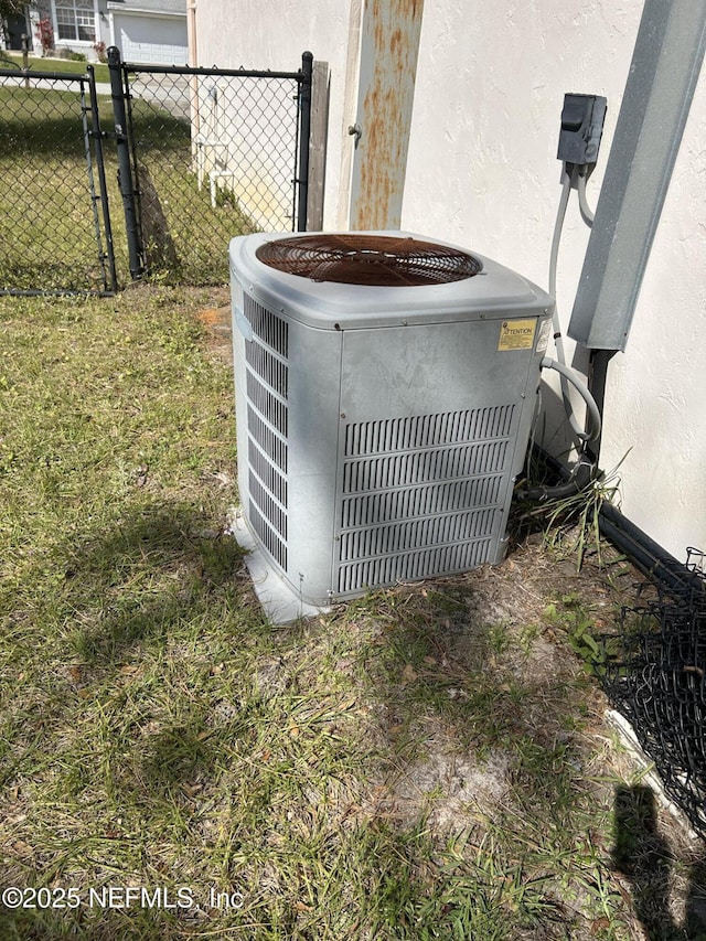 exterior details featuring central air condition unit, stucco siding, and fence