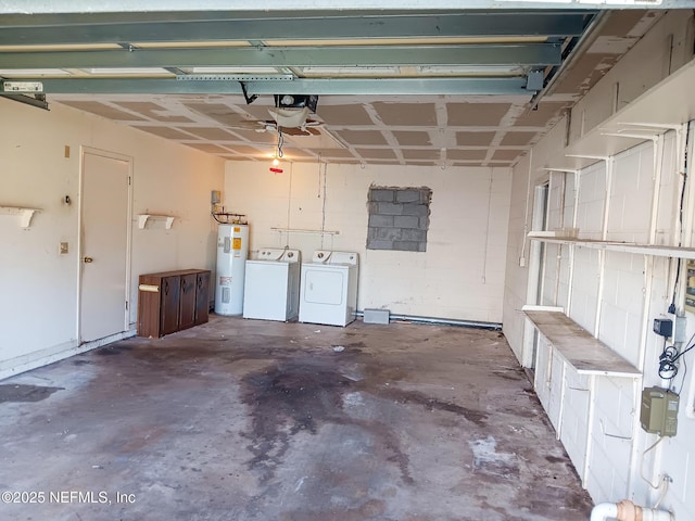 garage featuring concrete block wall, water heater, and washer and clothes dryer