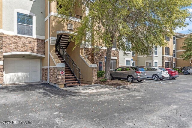 8539 Gate Pkwy W Unit 1723, Jacksonville, FL 32216 - view of property with stairway and an attached garage
