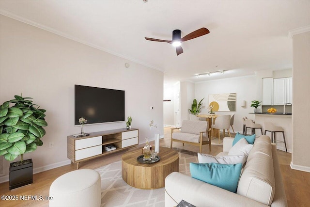 8539 Gate Pkwy W Unit 1723, Jacksonville, FL 32216 - living room featuring wood finished floors, a ceiling fan, baseboards, and ornamental molding