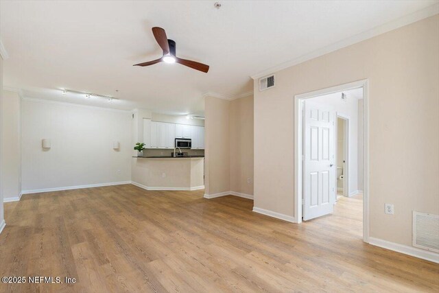 8539 Gate Pkwy W Unit 1723, Jacksonville, FL 32216 - unfurnished living room with visible vents, baseboards, light wood-style floors, and a ceiling fan