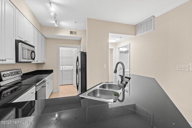 8539 Gate Pkwy W Unit 1723, Jacksonville, FL 32216 - kitchen with visible vents, independent washer and dryer, appliances with stainless steel finishes, and a sink