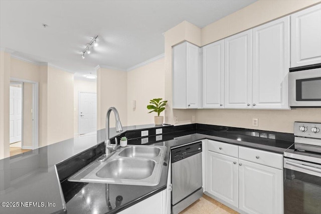 8539 Gate Pkwy W Unit 1723, Jacksonville, FL 32216 - kitchen featuring a sink, crown molding, appliances with stainless steel finishes, white cabinetry, and dark countertops