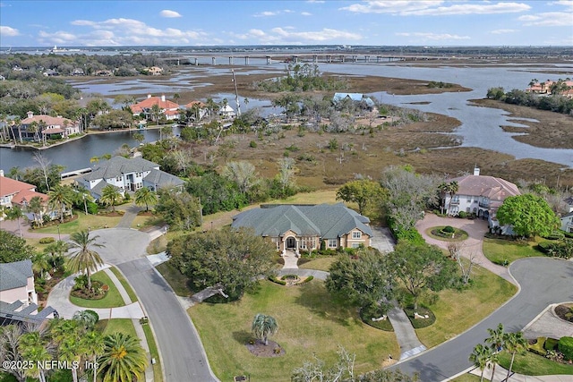 birds eye view of property with a residential view and a water view