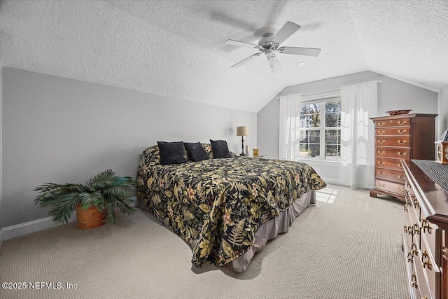 bedroom with light colored carpet, a textured ceiling, ceiling fan, and vaulted ceiling