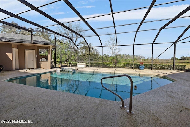 view of swimming pool with a patio area, glass enclosure, and a pool with connected hot tub