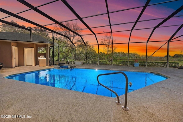 pool at dusk with a lanai, a pool with connected hot tub, and a patio