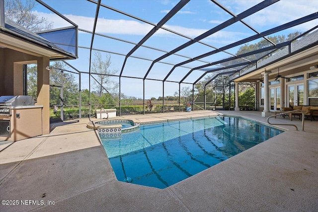 view of swimming pool with french doors, a patio, exterior kitchen, and glass enclosure