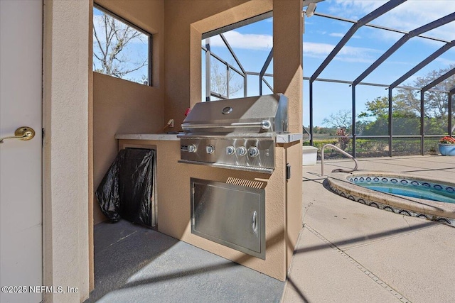 view of patio / terrace featuring grilling area, glass enclosure, an in ground hot tub, and exterior kitchen