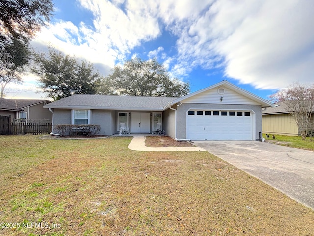 ranch-style house featuring an attached garage, fence, concrete driveway, and a front yard