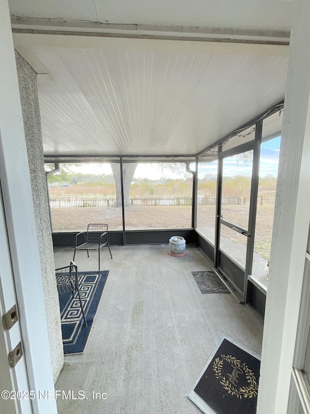 unfurnished sunroom featuring a wealth of natural light