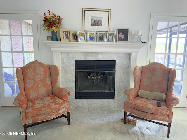 sitting room featuring carpet and a fireplace