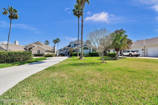 view of front of property featuring a front yard and concrete driveway