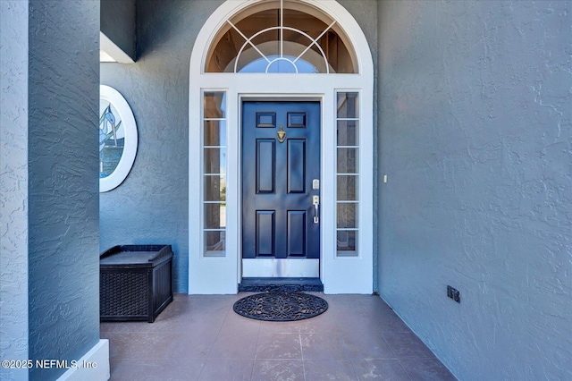 property entrance with stucco siding