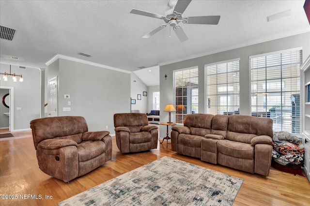 living area featuring light wood-style flooring, plenty of natural light, a ceiling fan, and visible vents